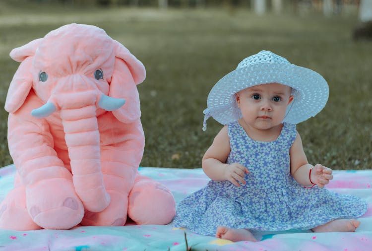 Baby Sitting Beside A Stuffed Toy