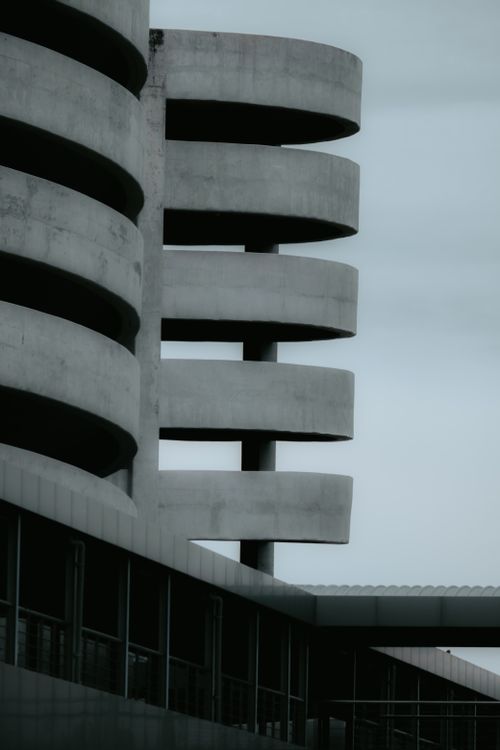 Free A striking view of a modern concrete spiral building structure on an overcast day. Stock Photo