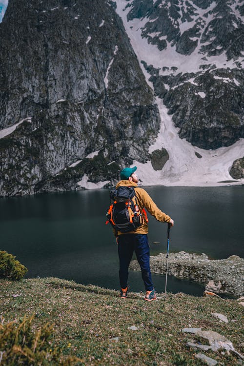 Back View of a Man Standing Outdoors with His Hiking Gear