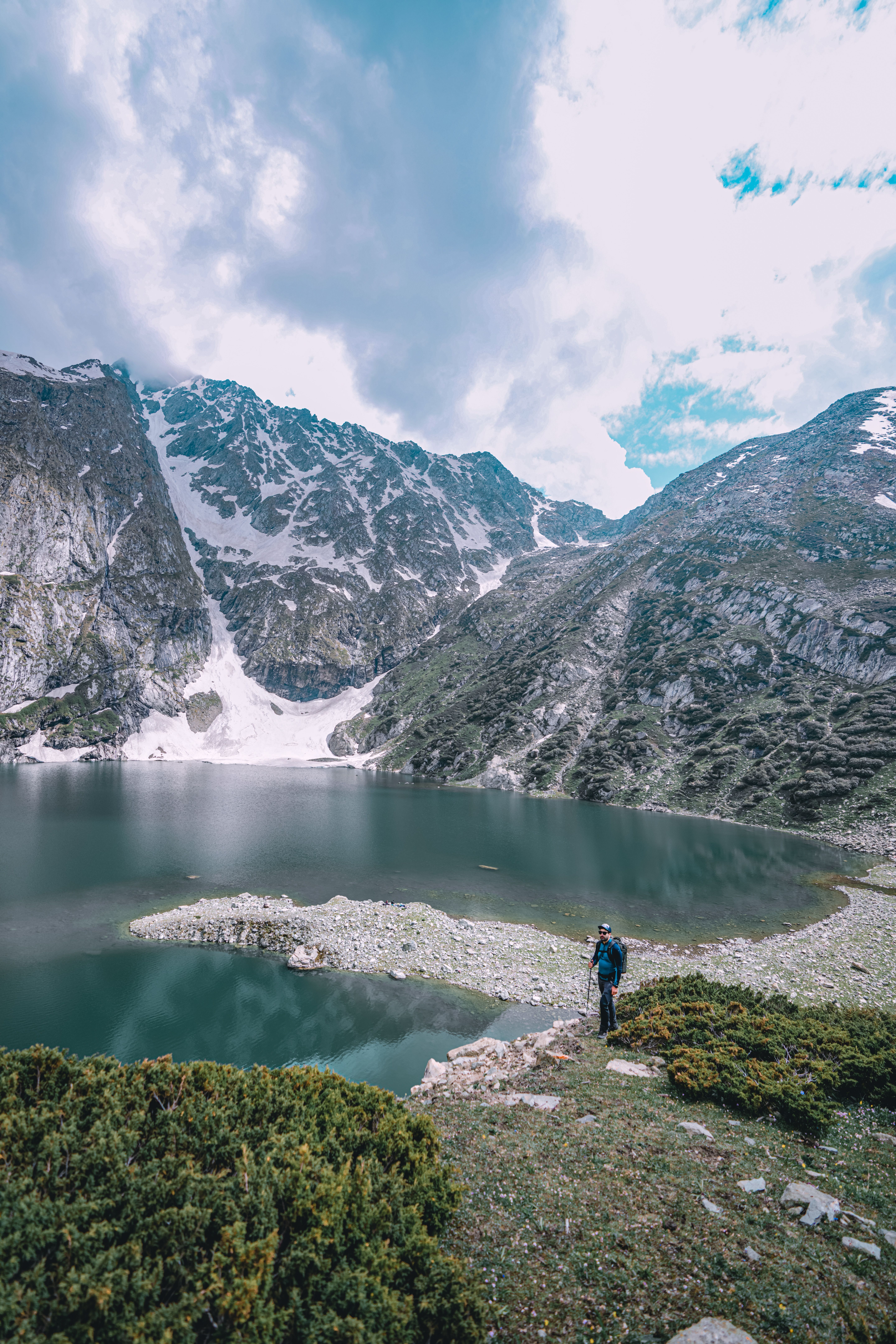 Majestic mountain lake surrounded by stunning peaks and snow, perfect for adventure seekers.