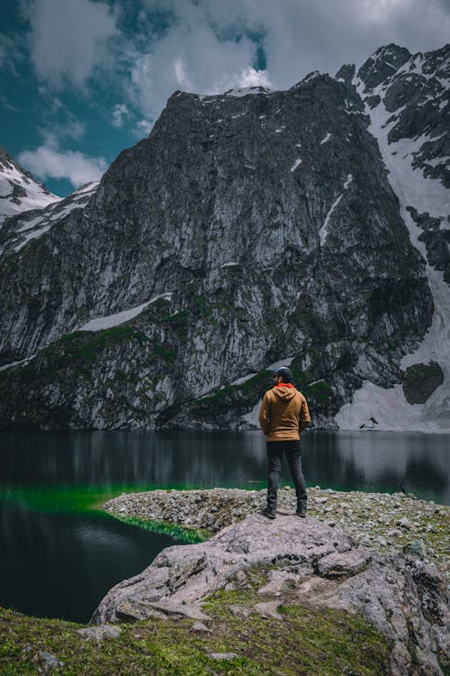 A Man Standing by a Lake