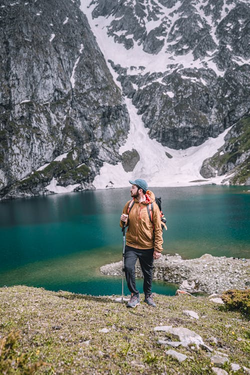 A Man Standing in Front of a Lake · Free Stock Photo