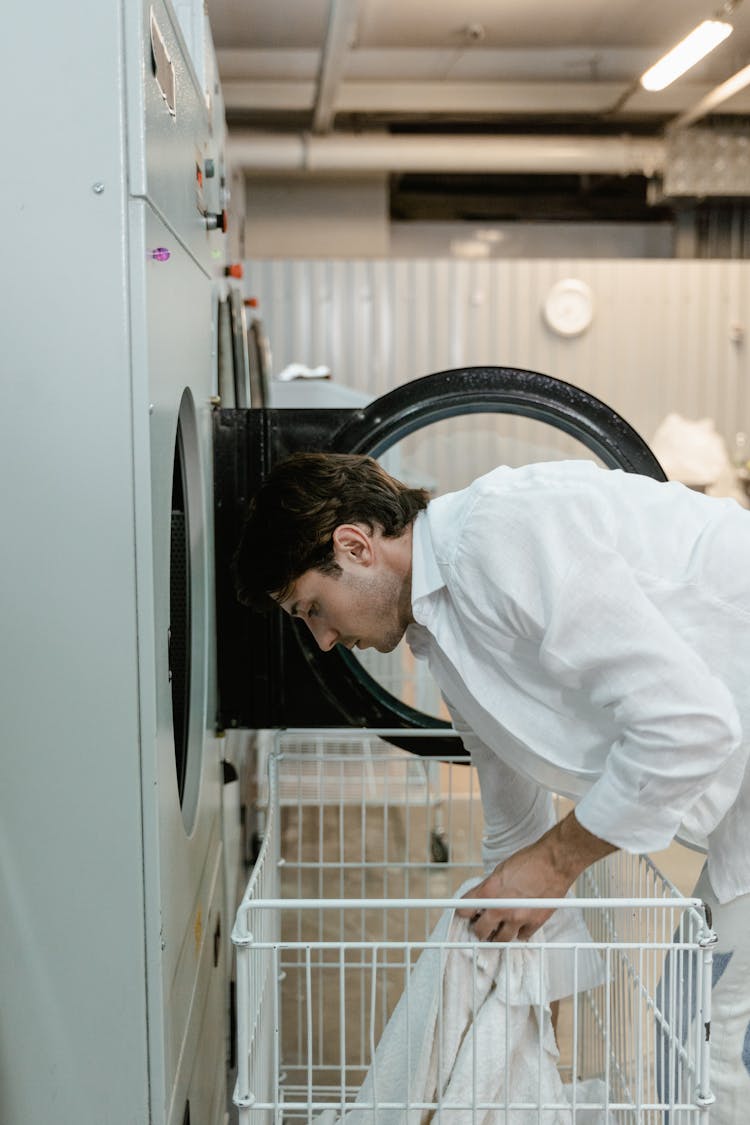 A Man Using A Self-Service Laundry