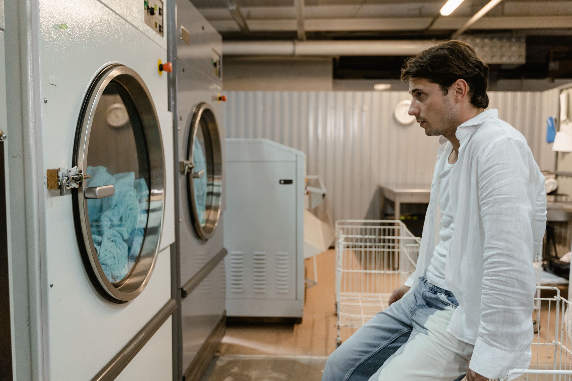 Man Looking at Washing Machines