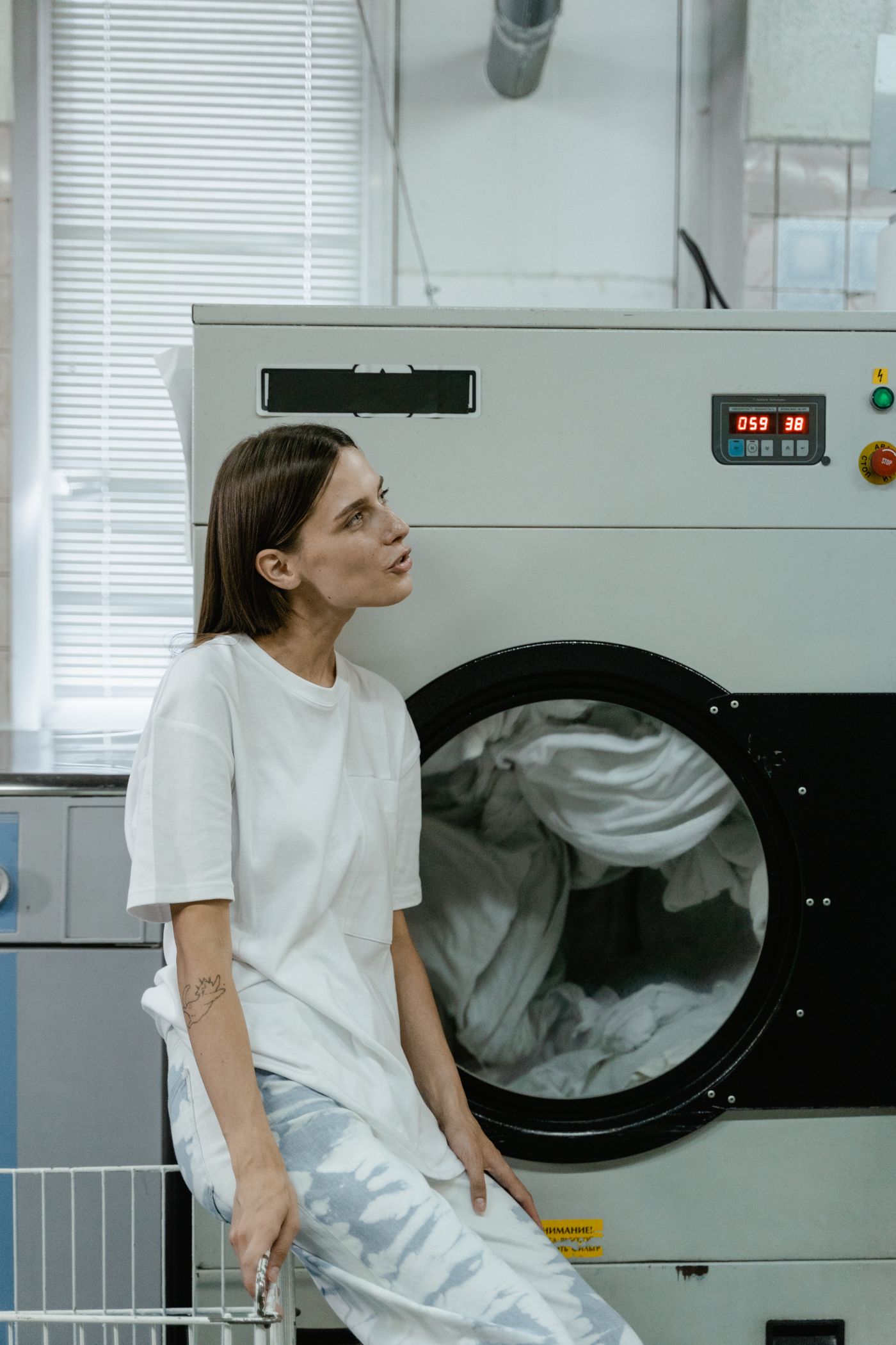 Customer waiting comfortably in a bright modern laundromat