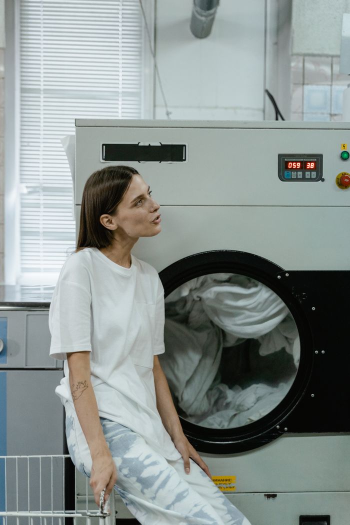Customer waiting comfortably in a bright modern laundromat