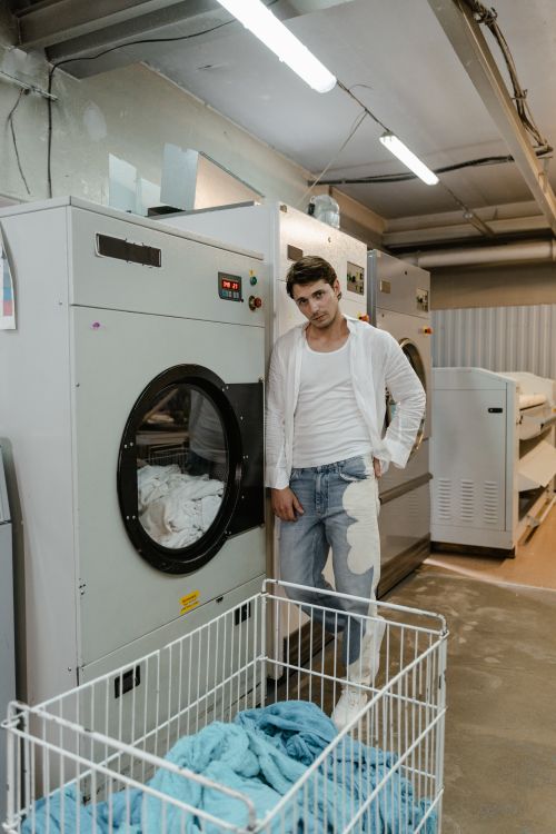 Technician repairing a Maytag brand laundry appliance