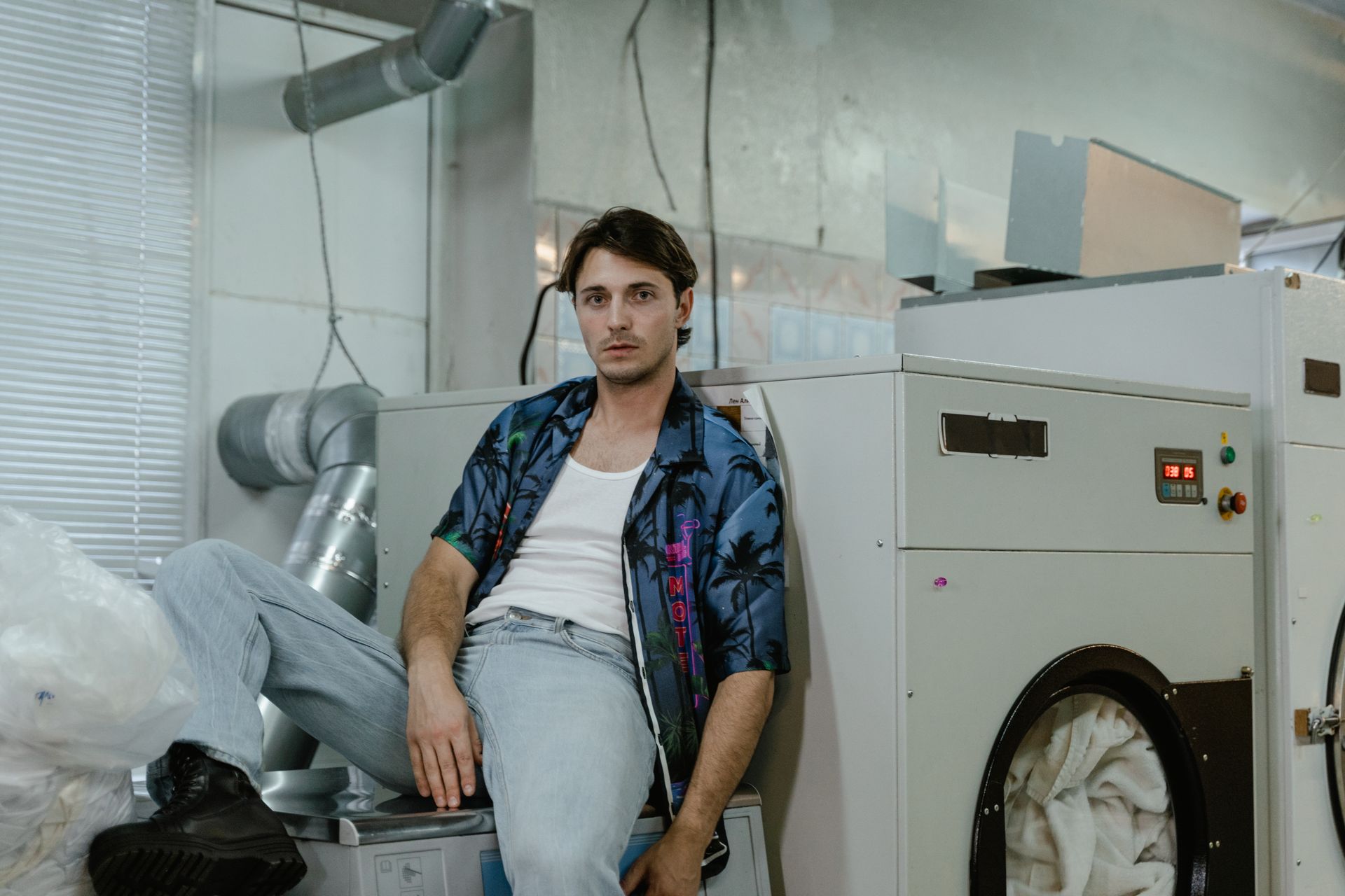 A Man Sitting on Washing Machine