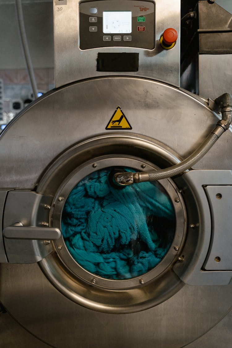 Blue Fabric Spinning Inside A Washing Machine