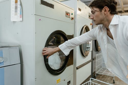 Free Man Holding the Washing Machine Door Stock Photo
