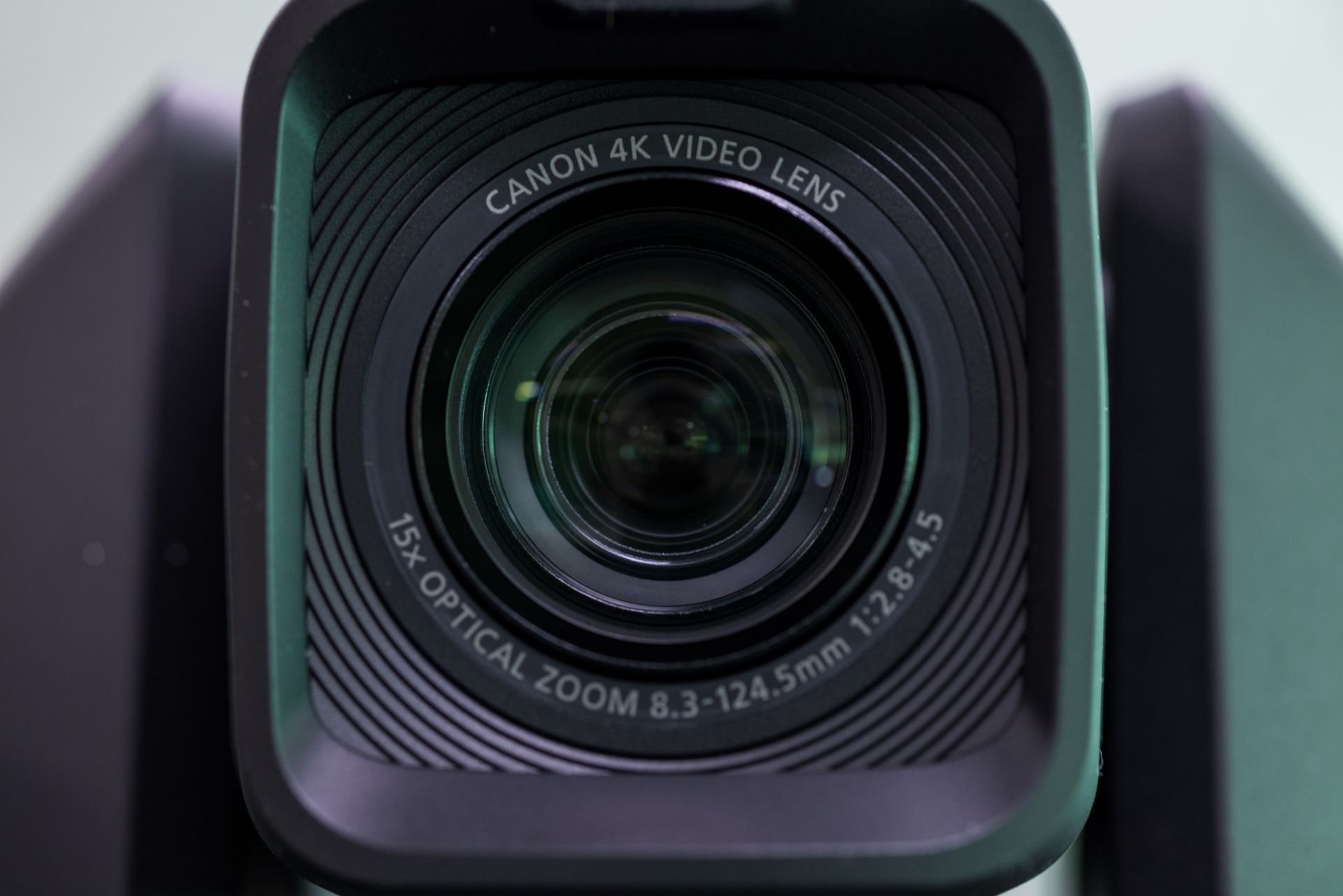 Detailed view of a Canon 4K video lens highlighting its optical zoom and video capabilities.