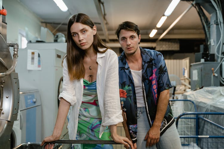 Woman And Man Standing At The Laundry Area