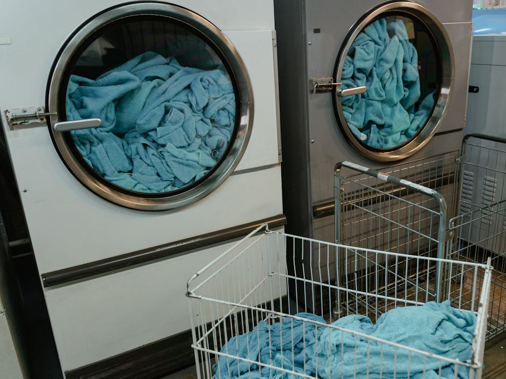Free White and Gray Washing Machine with Blue Fabrics inside Stock Photo
