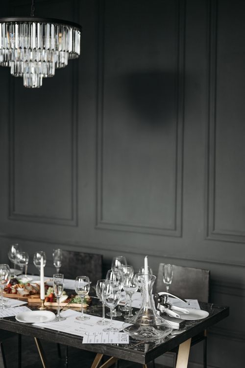 Free Luxurious table setting with wine glasses, candles, and chandelier in a sophisticated atmosphere. Stock Photo