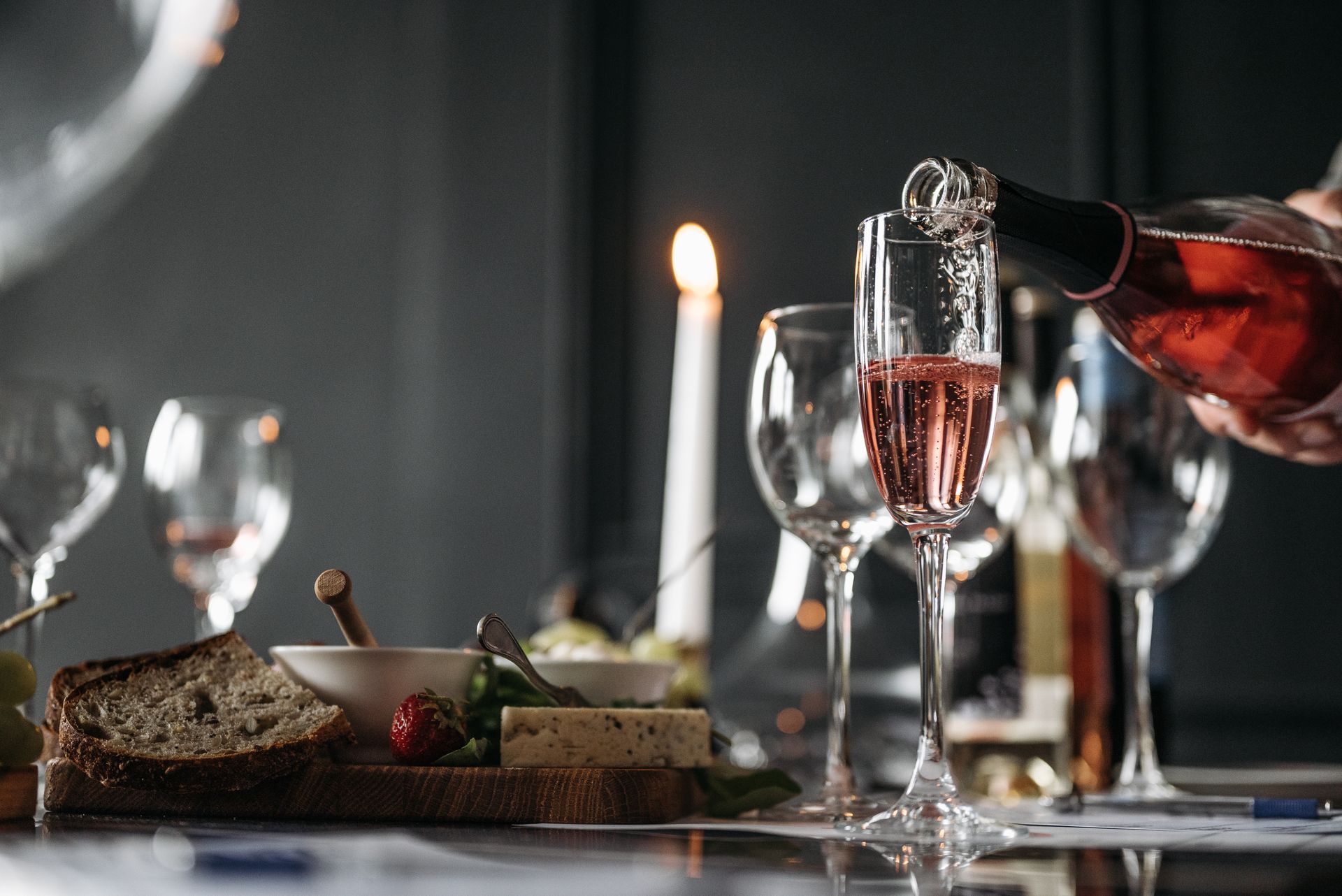 Elegant dinner setting with champagne, candlelight, and gourmet food for a sophisticated dining experience.