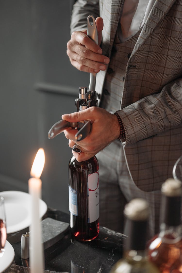 Person Holding Stainless Steel Bottle Opener