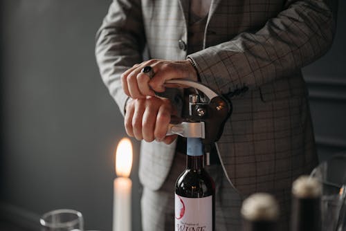 Free Person Opening a Wine Bottle Stock Photo