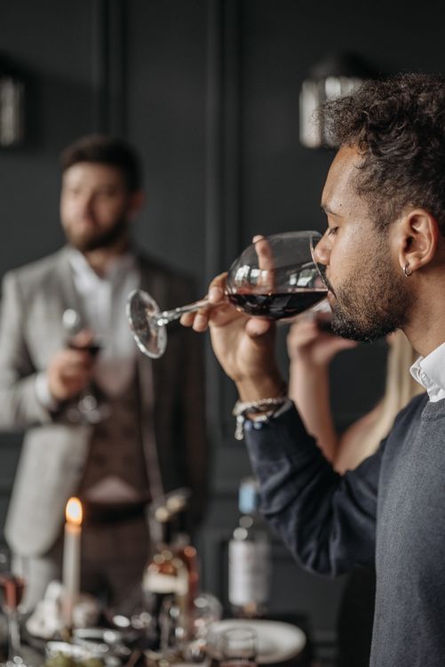 Guests enjoying wine glasses at an elegant indoor wine tasting event