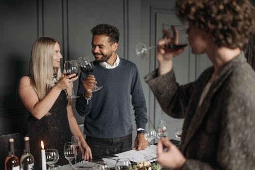 Adults enjoying an elegant wine tasting event, toasting with glasses indoors.