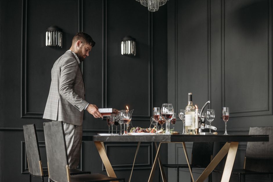 waiter pouring red wine