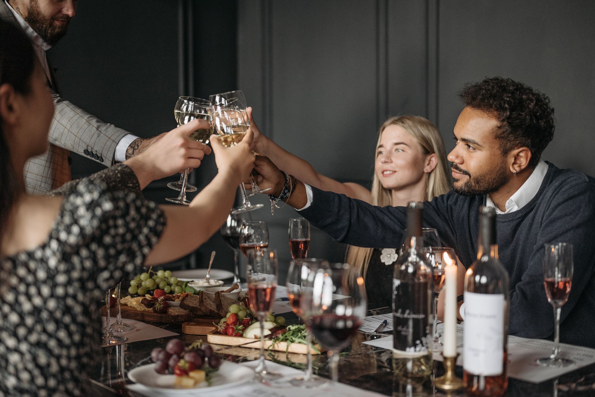 Friends sharing wine around a dinner table