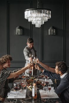 A diverse group of adults toasting with wine at a sophisticated dinner setting.