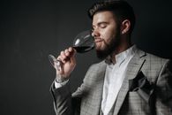 Man in Gray Suit Holding Wine Glass