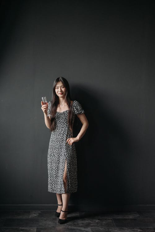 Woman Wearing Elegant Dress and Drinking Red Wine 