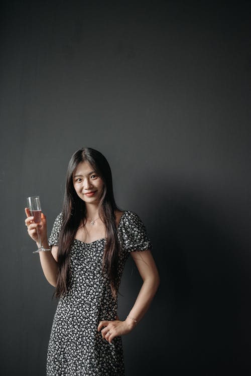 A Woman Holding a Glass of White Wine