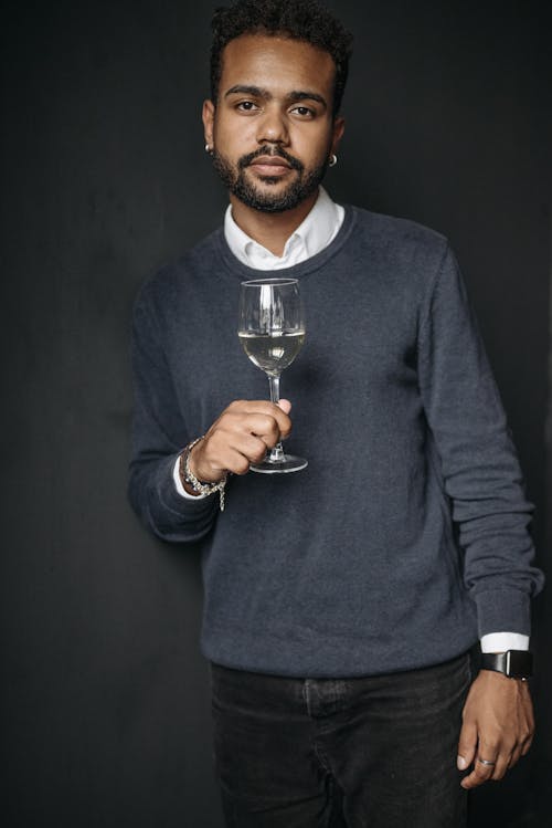 A Man in Long Sleeve Shirt Holding a Wine Glass