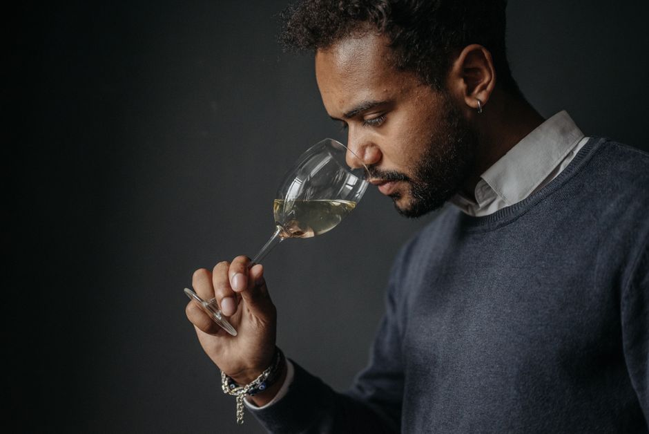 Person smelling wine thoughtfully - wine pairing guide Person smelling wine thoughtfully - wine pairing guide