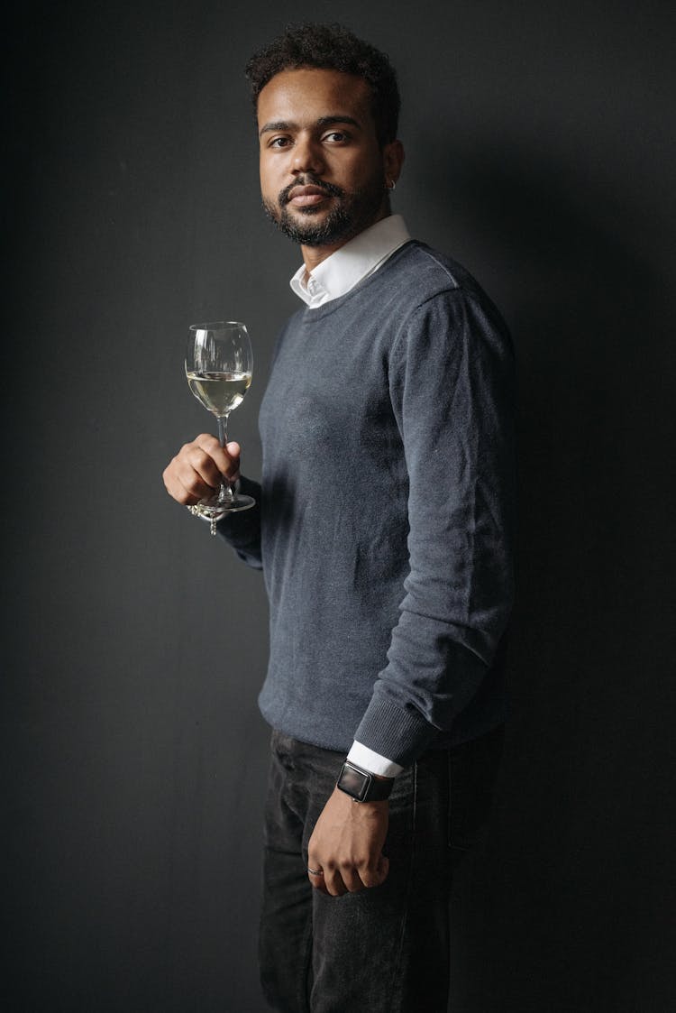 Man In Blue Sweater Holding Wine Glass