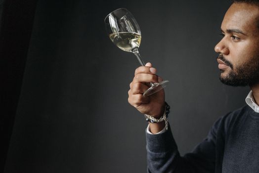 person analyzing wine glass