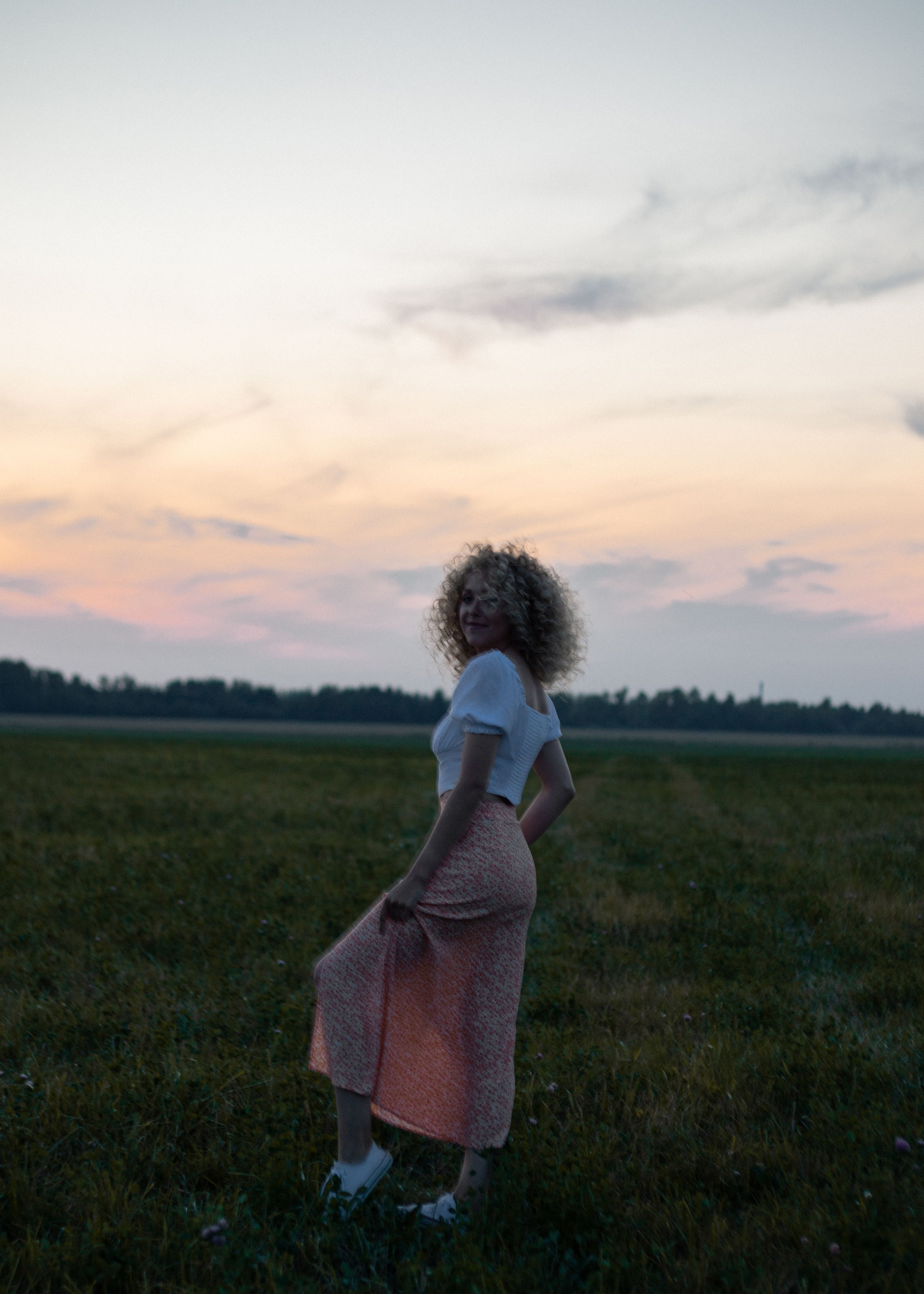 Woman in White Shirt Standing on Green Grass Field · Free Stock Photo