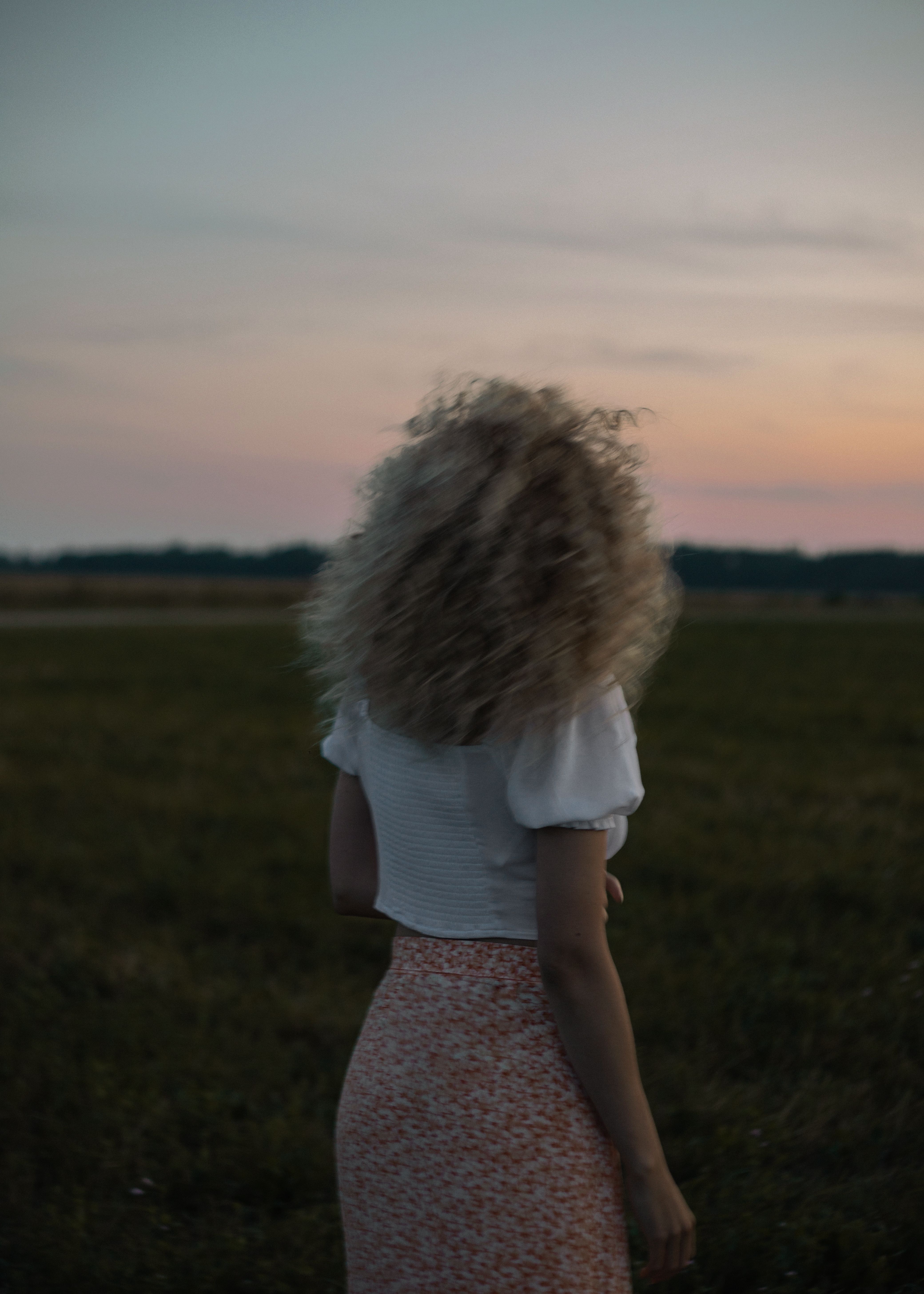 Woman in White Shirt Standing on Green Grass Field · Free Stock Photo