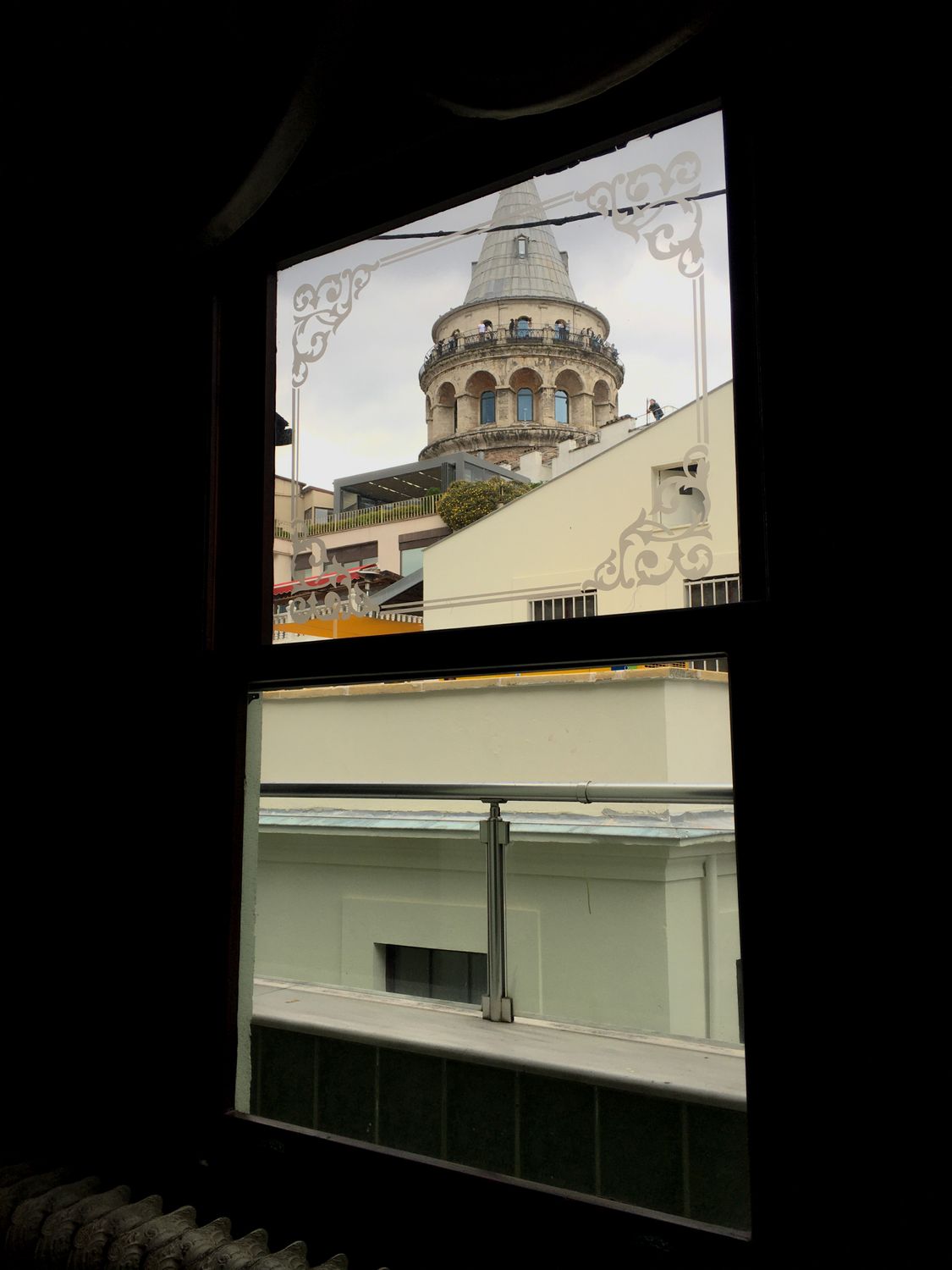 A View Of The Galata Tower From Inside A Room Free Stock Photo a-view-of-the-galata-tower-from-inside-a-room-free-stock-photo