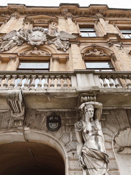 Free Detailed view of an ornate renaissance building facade with stone sculptures and intricate carvings. Stock Photo