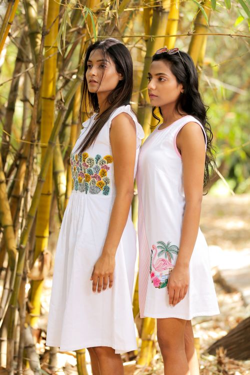 Free Two women wearing sleeveless dresses stand among bamboo in India, showcasing summer style. Stock Photo