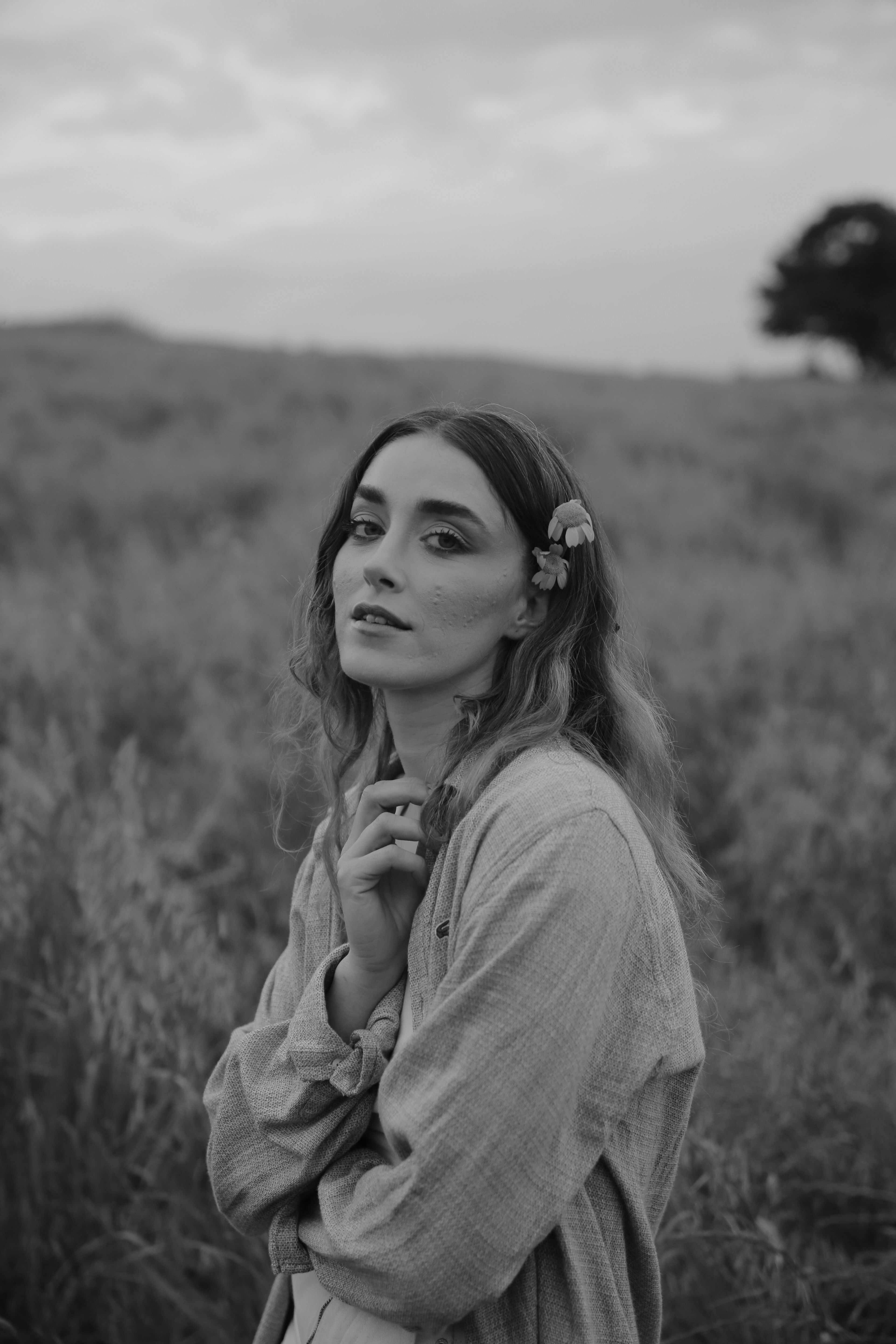 Grayscale Photo of a Woman in Black Dress Posing on a Grassy Field ...