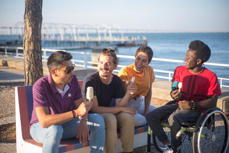 People Holding Ice Cream While Sitting On A Bench