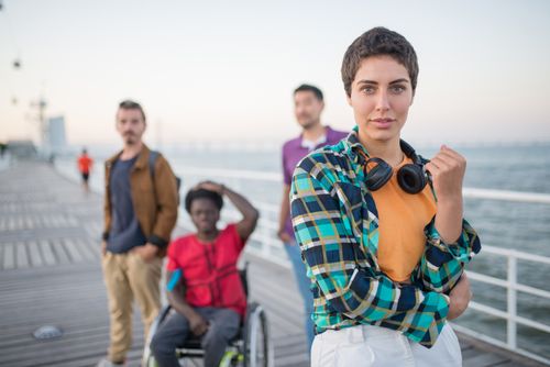Free A diverse group of friends posing on a pier in Portugal with scenic ocean views. Stock Photo