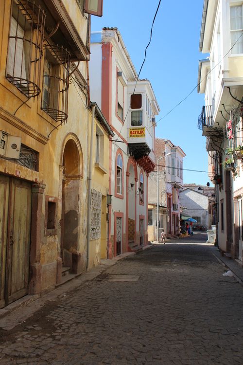 Free Discover a narrow, cobblestone street lined with vibrant historical buildings in a quiet residential area. Stock Photo