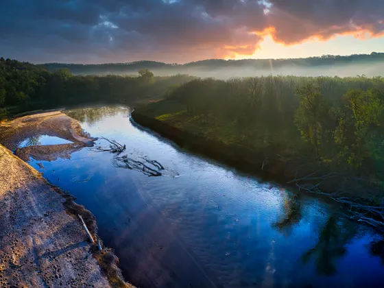The clear, spring-fed Niobrara River through a wooded canyon