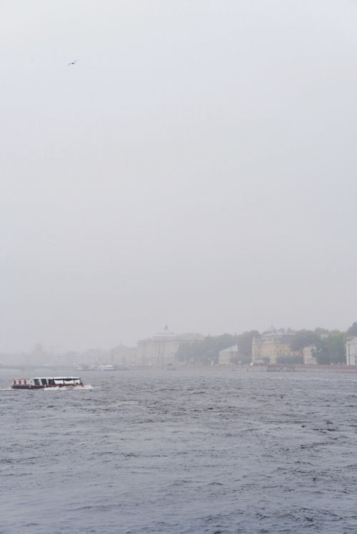 Free A serene view of a boat on the Neva River in foggy St. Petersburg, Russia. Stock Photo