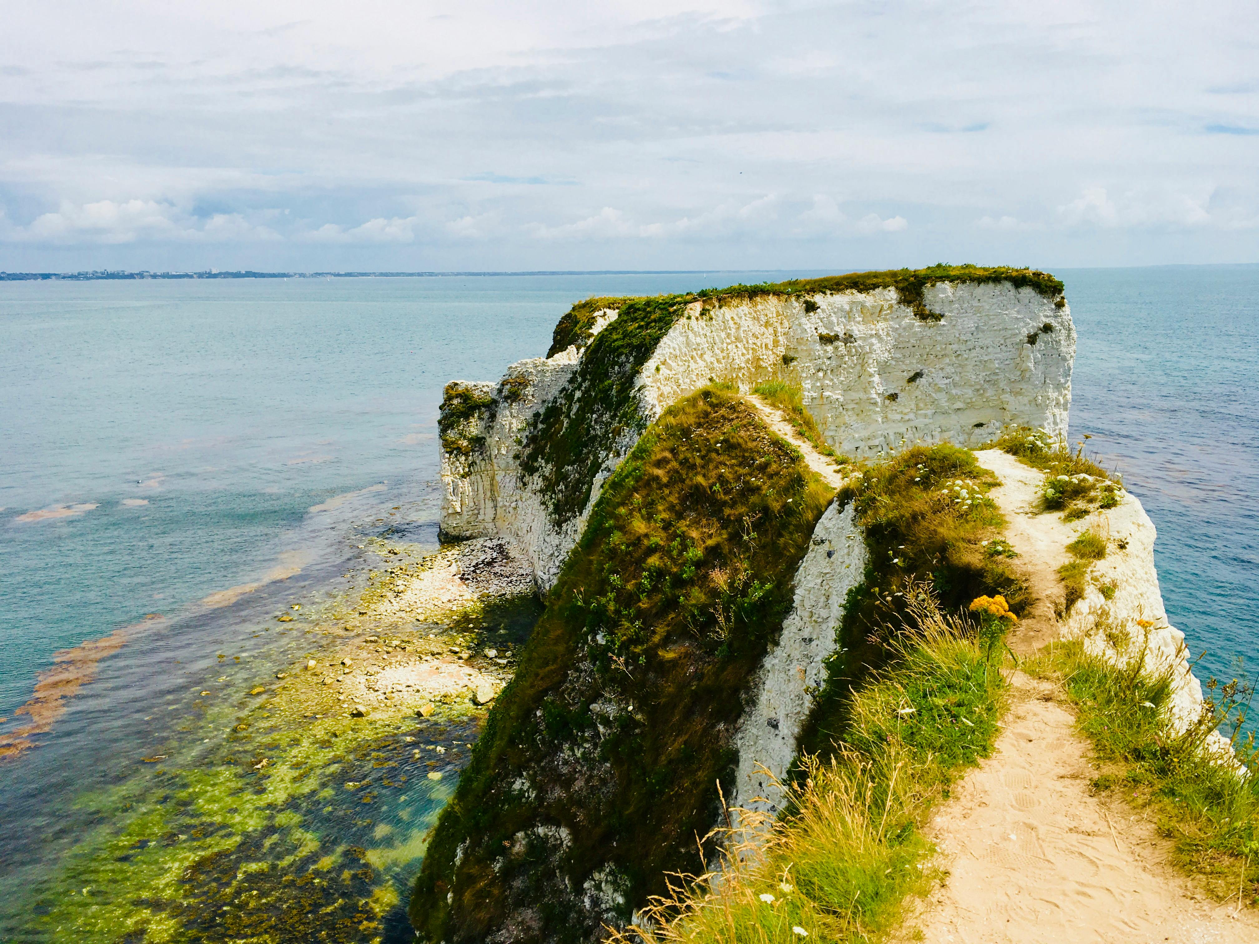 Rock Cliff Near Seashore · Free Stock Photo