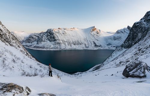 Free Explore the tranquil beauty of a winter fjord in Lenvik, Norway, surrounded by snow-covered mountains. Stock Photo