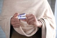 Person Holding White and Blue Card