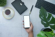 Person Holding White Box Near Black Laptop Computer