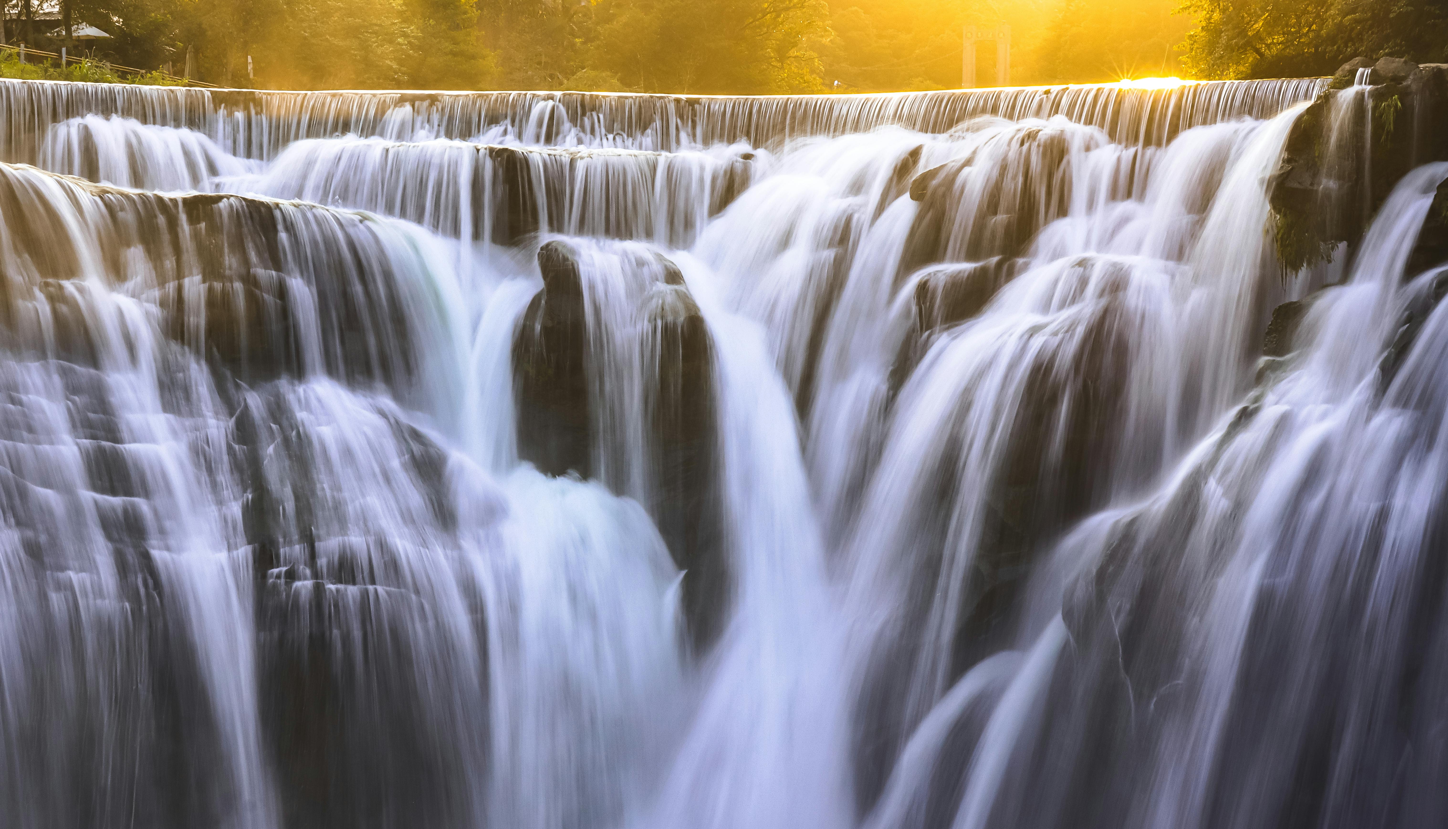 A mesmerizing view of Shifen Waterfall captured during golden hour, emphasizing its cascading beauty.