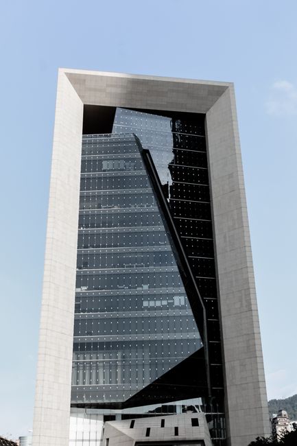 A striking example of modern architecture with glass panels in downtown Taipei.